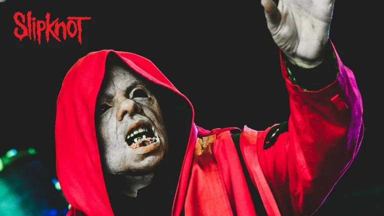 Sid Wilson in costume playing for Slipknot, with the logo in the top left